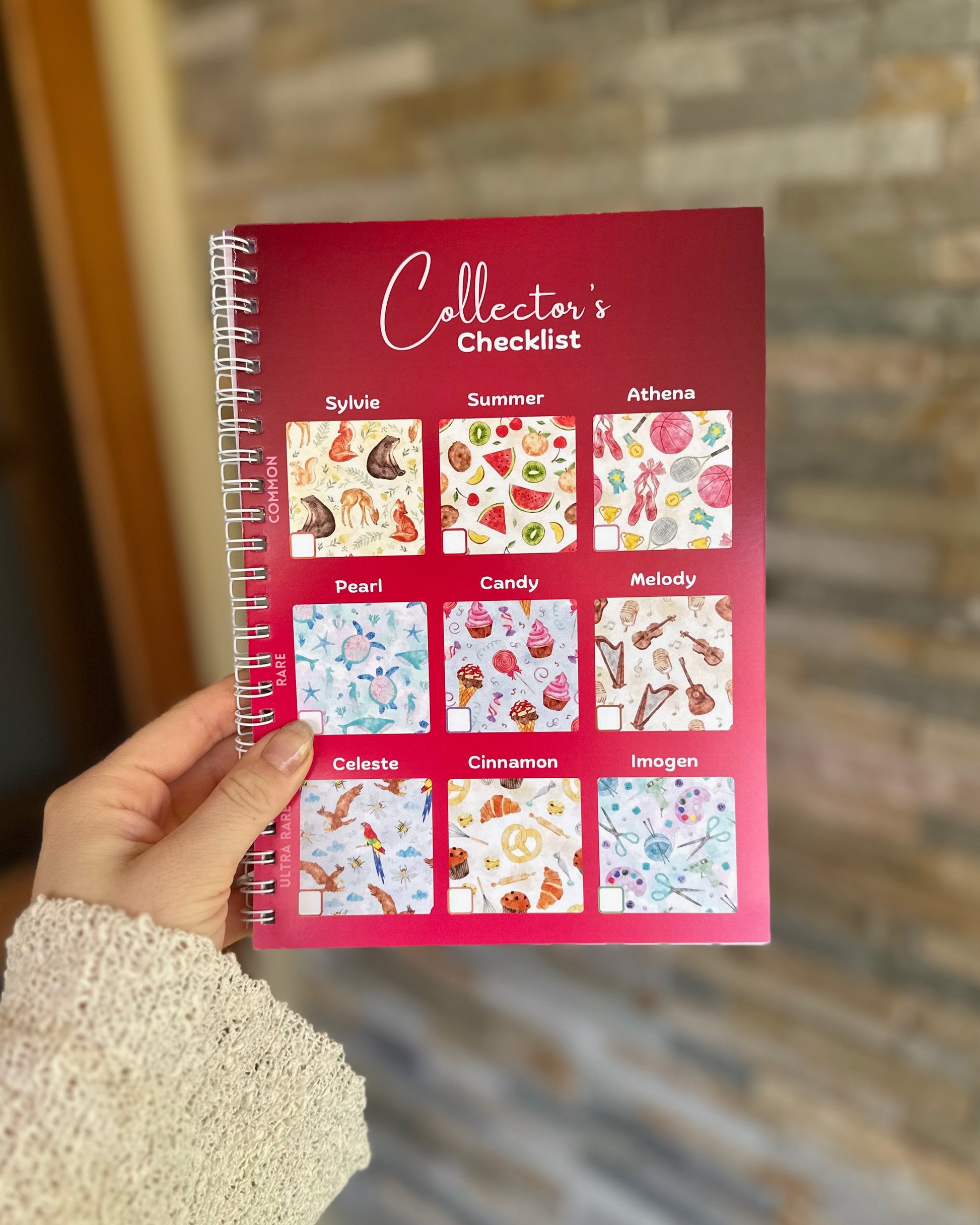 Via Pia collectible fabric checklist page from the guidebook, held in hand.